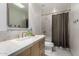 Bathroom featuring quartz countertops and a shower with bronze finishes at 106 E Echo Ln, Phoenix, AZ 85020