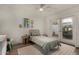 Bright bedroom featuring hardwood floors, ceiling fan, and access to the outdoor space at 106 E Echo Ln, Phoenix, AZ 85020