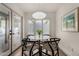 Cozy dining area with modern lighting, a round table, and patio access at 106 E Echo Ln, Phoenix, AZ 85020