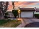 Charming home featuring a lush yard, and a well-maintained two-car garage with a brick-paved driveway at 106 E Echo Ln, Phoenix, AZ 85020