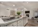 Bright kitchen with marble countertops, a modern cooktop, and an open layout to the living area at 106 E Echo Ln, Phoenix, AZ 85020