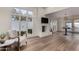 Comfortable living room with hardwood floors, a fireplace, a large window, and stylish decor at 106 E Echo Ln, Phoenix, AZ 85020