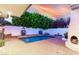 Private pool area with a unique fountain feature and an outdoor fireplace, perfect for relaxing evenings at 106 E Echo Ln, Phoenix, AZ 85020