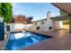 Backyard pool with a fireplace and pergola, designed for both relaxation and outdoor entertaining at 106 E Echo Ln, Phoenix, AZ 85020