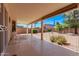 Comfortable covered back patio area, ideal for relaxing and enjoying the outdoor space with beautiful plants at 10937 N Ventana W Dr, Peoria, AZ 85373