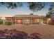 Expansive backyard showcasing covered patio, dining set, lounge chair, and mature landscaping with privacy bushes at 10937 N Ventana W Dr, Peoria, AZ 85373