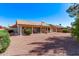 Large backyard featuring a low-maintenance desert landscape with a covered patio, ideal for outdoor living at 10937 N Ventana W Dr, Peoria, AZ 85373