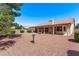 Spacious backyard area with desert landscaping and a covered patio, perfect for outdoor gatherings and relaxation at 10937 N Ventana W Dr, Peoria, AZ 85373