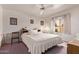 Cozy bedroom with a ceiling fan, a window view, and traditional furnishings at 10937 N Ventana W Dr, Peoria, AZ 85373