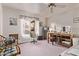 Bedroom with a ceiling fan, a window, a desk, and a seating area at 10937 N Ventana W Dr, Peoria, AZ 85373