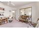 View of a bedroom with mirrored closet doors, ceiling fan, and attached bathroom at 10937 N Ventana W Dr, Peoria, AZ 85373