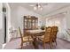 Well-lit dining room with wooden table, chairs, and a decorative china cabinet at 10937 N Ventana W Dr, Peoria, AZ 85373