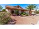 Attractive home featuring a well-maintained lawn, tile roofing, decorative columns, and manicured shrubbery and greenery at 10937 N Ventana W Dr, Peoria, AZ 85373