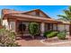 Attractive home featuring a well-maintained lawn, tile roofing, decorative columns, and manicured shrubbery and greenery at 10937 N Ventana W Dr, Peoria, AZ 85373