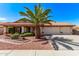 Inviting home with lush landscaping, a mature palm tree, tile roof, and three-car garage with an extended driveway at 10937 N Ventana W Dr, Peoria, AZ 85373
