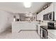 Clean kitchen with white cabinets and tiled countertops, offering a bright space at 10937 N Ventana W Dr, Peoria, AZ 85373