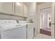 Well-lit laundry room featuring a white washer and dryer and plenty of storage space at 10937 N Ventana W Dr, Peoria, AZ 85373