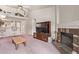 Vaulted living room with fireplace, adjacent to kitchen with breakfast bar at 10937 N Ventana W Dr, Peoria, AZ 85373