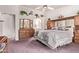 Spacious main bedroom showing a large bed, dresser, and decor, with an arched entrance to the bathroom at 10937 N Ventana W Dr, Peoria, AZ 85373