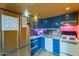 Modern kitchen features blue cabinets, stainless steel appliances, and ample counter space at 1123 E Maryland Ave # 4, Phoenix, AZ 85014