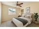 Neutral bedroom featuring a ceiling fan, large window and closet at 1202 W Wickieup Ln, Phoenix, AZ 85027