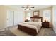 Cozy bedroom with a ceiling fan, carpet flooring, and a comfortable bed with a wood headboard at 1202 W Wickieup Ln, Phoenix, AZ 85027