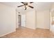 Comfortable bedroom featuring tile floors, ceiling fan, and access to other rooms at 1202 W Wickieup Ln, Phoenix, AZ 85027