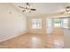 Bright dining area with tile flooring, fan, multiple windows, and access to the backyard at 1202 W Wickieup Ln, Phoenix, AZ 85027
