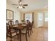Traditional dining room showcasing a ceiling fan, and a wood table with six upholstered chairs at 1202 W Wickieup Ln, Phoenix, AZ 85027