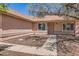 Welcoming front entrance with a cozy porch and neatly landscaped garden at 1202 W Wickieup Ln, Phoenix, AZ 85027