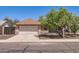 View of the home's front exterior and two car garage at 1202 W Wickieup Ln, Phoenix, AZ 85027