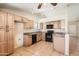 Open kitchen with updated appliances, granite counters, and tiled floors at 1202 W Wickieup Ln, Phoenix, AZ 85027