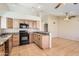 Functional kitchen with modern appliances, bar seating, and an open layout at 1202 W Wickieup Ln, Phoenix, AZ 85027