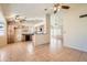 Open-concept living space features tile flooring, natural light, and flows into kitchen area at 1202 W Wickieup Ln, Phoenix, AZ 85027