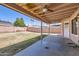 View of covered patio and spacious backyard with block fencing at 1202 W Wickieup Ln, Phoenix, AZ 85027