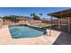 Sparkling backyard swimming pool is fenced for added safety at 1202 W Wickieup Ln, Phoenix, AZ 85027