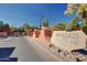 Community entrance sign with lush landscaping and clear blue sky at 12212 N Paradise Vlg S Pkwy # 113, Phoenix, AZ 85032