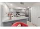 Well-lit kitchen with gray cabinetry, stainless steel appliances, and skylight at 12212 N Paradise Vlg S Pkwy # 113, Phoenix, AZ 85032