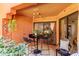Cozy outdoor patio with table, chairs, and decorative string lights at 12212 N Paradise Vlg S Pkwy # 113, Phoenix, AZ 85032