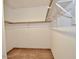 Empty walk-in closet with tile floor and wall-mounted shelving at 12965 N 95Th Way, Scottsdale, AZ 85260