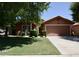 Charming single-story home featuring a well-maintained lawn and a two-car garage, in a suburban neighborhood at 12965 N 95Th Way, Scottsdale, AZ 85260