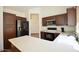 An open kitchen has stainless steel appliances, wood cabinetry, granite countertops and plenty of room to cook at 12965 N 95Th Way, Scottsdale, AZ 85260