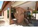 Enjoy this covered patio with ceiling fan and wolf artwork, perfect for outdoor relaxation and entertaining at 12965 N 95Th Way, Scottsdale, AZ 85260