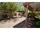 Lush backyard oasis with mature trees, covered patio, brick border and desert landscaping at 12965 N 95Th Way, Scottsdale, AZ 85260