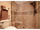 Walk-in shower has tile surround with shower head and small bench at 12965 N 95Th Way, Scottsdale, AZ 85260