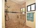 Tile shower has a glass door and shower head at 12965 N 95Th Way, Scottsdale, AZ 85260