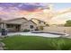 Fenced backyard with sparkling pool and covered patio area at 13723 W Rovey Ave, Litchfield Park, AZ 85340