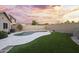 Private backyard features pool, patio and artificial turf lawn at 13723 W Rovey Ave, Litchfield Park, AZ 85340