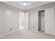 Bright bedroom features a ceiling fan, closet, and ensuite bathroom at 13723 W Rovey Ave, Litchfield Park, AZ 85340