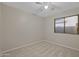 Bright bedroom features neutral decor and a window at 13723 W Rovey Ave, Litchfield Park, AZ 85340